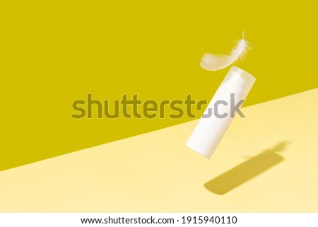 Creative layout with levitating beauty product on yellow background