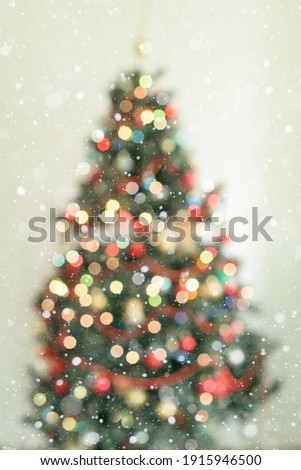Christmas and New Year interior - blur background:  green Christmas tree.  Lots of lights glowing .Bokeh