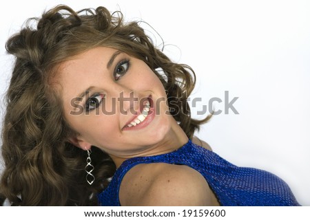 Head and shoulders of classy and sophisticated looking teen brunette model on white seamless background.