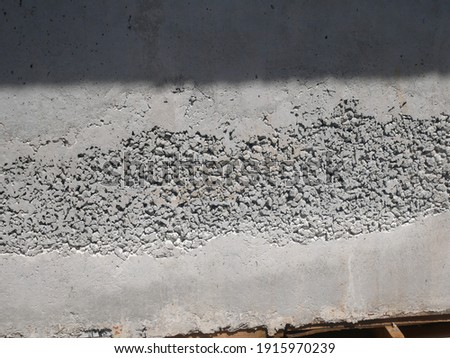 New fresh concrete surface with honeycomb problem and might expose reinforcement bar inside. The problem weakens concrete strength. 