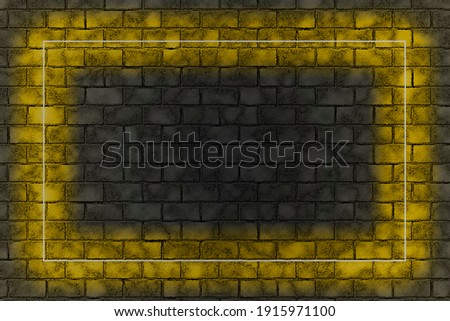 Yellow neon light frame on brick wall background. Dark empty room. Trendy color Ultimate Grey and Illuminating of the 2021 year