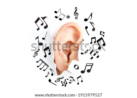 Ear-shaped piercing through the paper. Surrounded by musical notes of various sizes, suitable for use in art media, music media, advertising media.