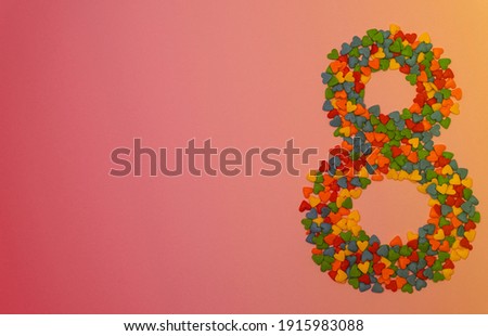  Greeting Card International Women's Day on March 8th. Colorful heart shape sweet candy  in the form of number eight. Happy Eighth birthday greeting card. Minimal concept.                             