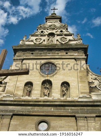 The facade of Roman Catholic Church and cross in Lviv. Ukraine. Europe