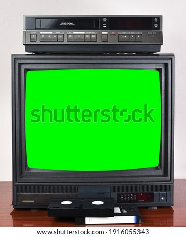 Old silver vintage TV with green screen to add new images to the screen, VCR on wallpaper background.	