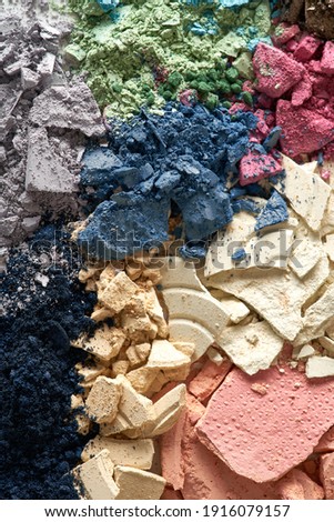 The texture of crumbled and crushed multi-colored eyeshadows. Broken cosmetics