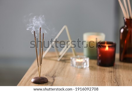 Incense sticks smoldering on table indoors, space for text Royalty-Free Stock Photo #1916092708