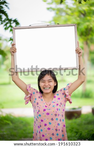 Portrait of young woman with blank white board