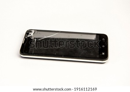 black smartphone with broken screen, isolated on a white background