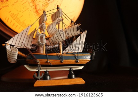 sailing ship standing in front of the world map