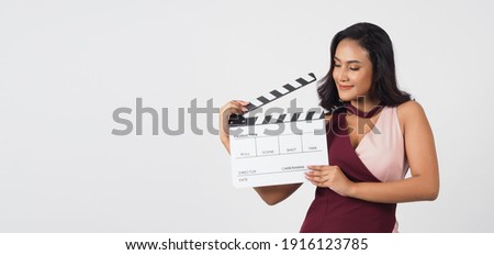 Asian woman hold clapper board or movie clapperboard on white background.She have tan skin ,show film,cinema production concept. 