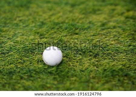 White golf ball On the green grass As a symbol of creativity Simple but striking design