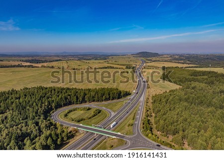 Aerial view of highway going through farm lands