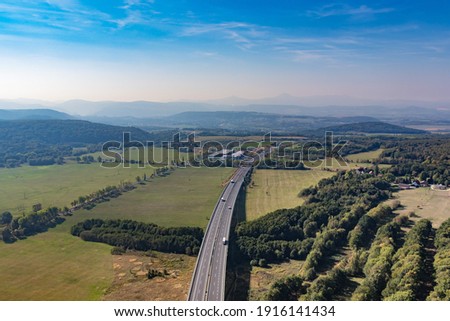 Aerial view of highway going through farm lands into Prague