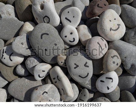 Emotion management concept, stones with painted faces symbolize different emotions. We are all different, but all together, learning to manage emotions Royalty-Free Stock Photo #1916199637