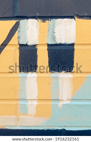 Colorful abstract geometric patterns painted on a brick wall 