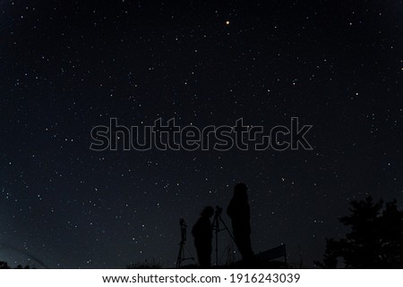 Two people starry sky photo in the mountains at night