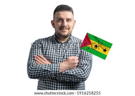 White guy holding a flag of Sao Tome and Principe smiling confident with crossed arms isolated on a white background.