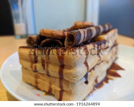 Picture of toast with chocolate jam and biscuit decoration on top