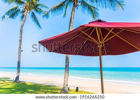 Empty deck chair lounge with umbrella around on beach sea ocean blue sky for leisure travel vacation