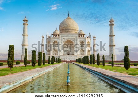 Taj Mahal front view reflected on the reflection pool, an ivory-white marble mausoleum on the south bank of the Yamuna river in Agra, Uttar Pradesh, India. One of the seven wonders of the world. Royalty-Free Stock Photo #1916282315