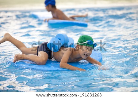 Boys of elementary school children playing in the pool