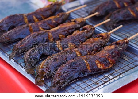 Grilled catfish on a wooden stick for sell