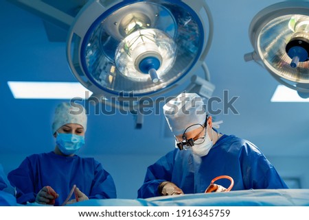 Team surgeon at work in operating room. Modern equipment in operating room.