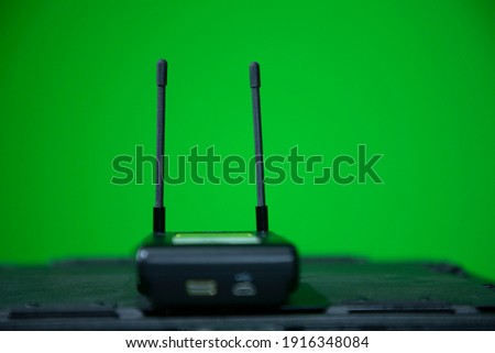 Close up view of wireless microphone receiver in chroma shooting studio