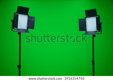 Green screen television studio with two fill lights. Lights are turn off in chroma studio