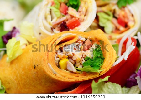 Wraps with vegetables and meat, closeup. 