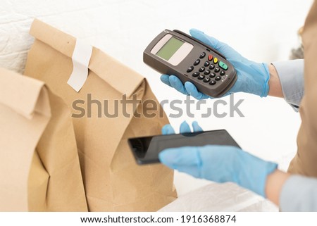 Seller holding payment pos terminal. Space for text