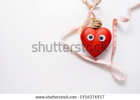 Heart with a centimeter on white backgriund