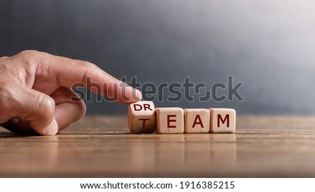 hand holding dice with text for illustration of "Dream team" words
 Royalty-Free Stock Photo #1916385215