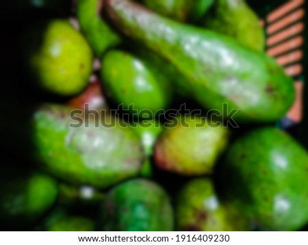 defocused abstract picture of green avocados
