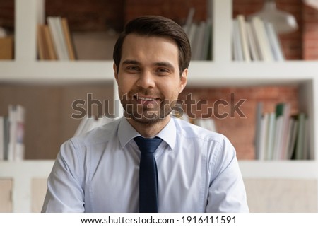 Profile picture of smiling young Caucasian businessman have webcam digital event online with client customer. Headshot portrait of happy male employee speak talk on video call with business partner.