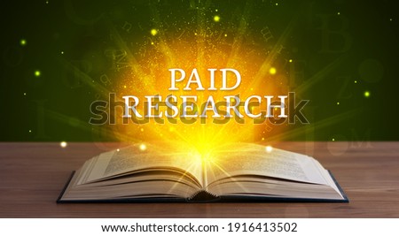 PAID RESEARCH inscription coming out from an open book, educational concept