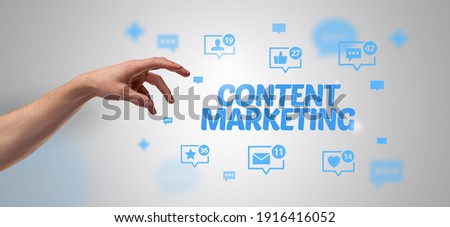 Close-Up of cropped hand pointing at CONTENT MARKETING inscription, social networking concept