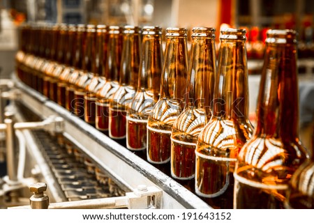 Beer bottles on the conveyor belt Royalty-Free Stock Photo #191643152