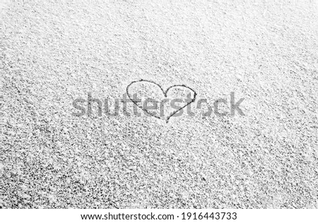 Heart painted on snow and there are and Many grains of white snow and snowflakes, February 14