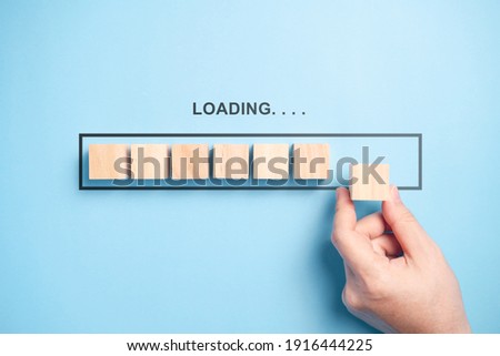 Loading bar with wooden blocks isolated on blue background. Royalty-Free Stock Photo #1916444225