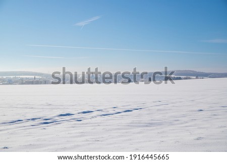 Panorama snow landscape with tracks and blue sky