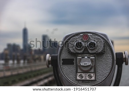 Binoculars overlooking New York City skyline with bokeh