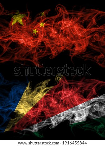 China, Chinese vs Seychelles, Seychellois smoky mystic flags placed side by side. Thick colored silky abstract smoke flags.