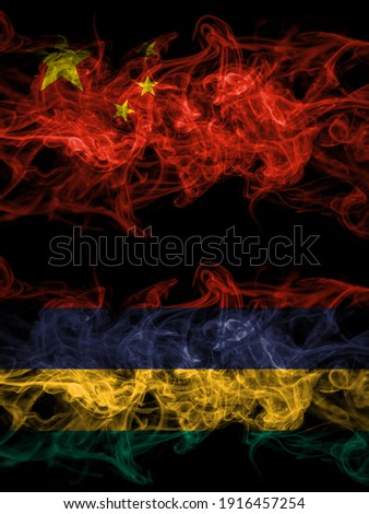 China, Chinese vs Mauritius smoky mystic flags placed side by side. Thick colored silky abstract smoke flags.