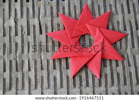 a red self-folded star on a cardboard cartoon