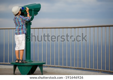 Child looking through coin operated binoculars
