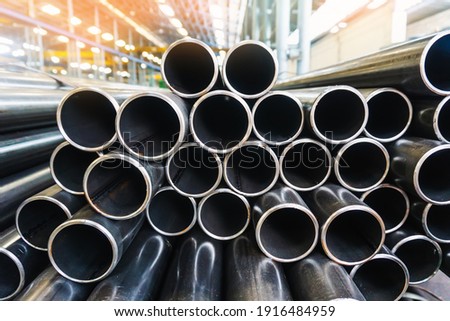 high quality Galvanized steel pipe or Aluminum and chrome stainless pipes in stack waiting for shipment  in warehouse Royalty-Free Stock Photo #1916484959