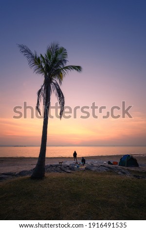 they are camping near the river and sunrise background.
