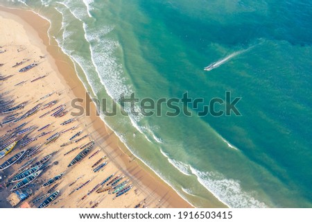 Aerial view of fishing village, pirogues fishing boats in Kayar, Senegal. Photo made by drone from above. Africa Landscapes. Royalty-Free Stock Photo #1916503415